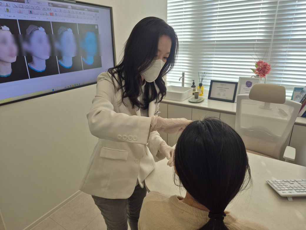 환자의 얼굴 좌우 차이를 살피는 최진숙 대표원장